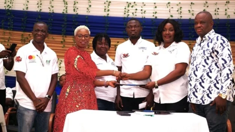 Comfort Ocran (left) and Mrs. Joana Eshun Mensah exchanging documents